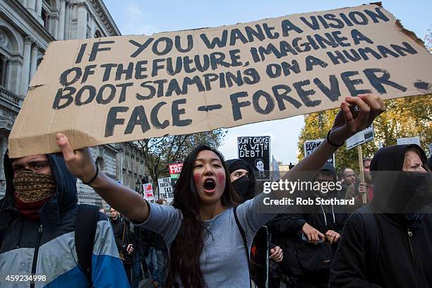 Protestors march down Whitehall during a protest against student university fees on November 19, 2014 in London, England. A coalition of student...