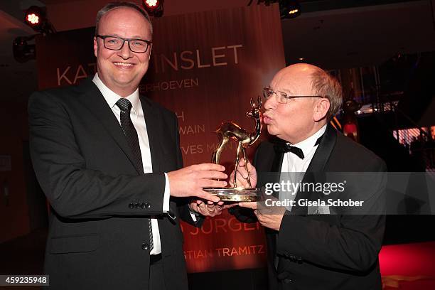 Cast members of the tv show 'heute show', Oliver Welke and Hans-Joachim Heist, pose with their award during Kryolan at the Bambi Awards 2014 on...