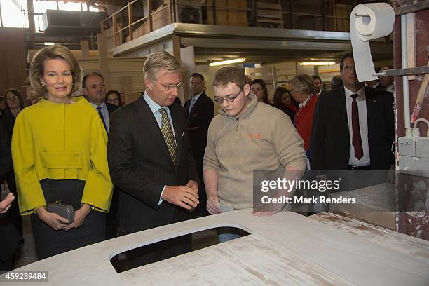 Queen Mathilde and King Philippe of Belgium visit Mathy by Bois in Couvin on November 19, 2014 in Namur, Belgium.