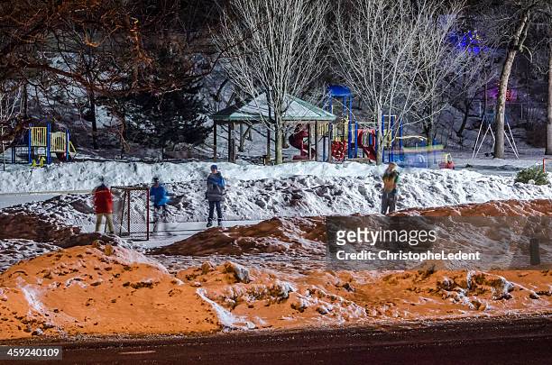 kids playing hockey on outdoor rink - ottawa park stock pictures, royalty-free photos & images