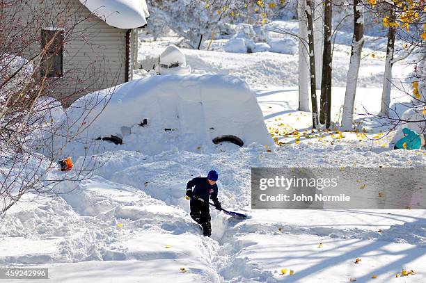 Drew Ahmed makes his way through nearly five feet of snow on November 19, 2014 in the Lakeview neighborhood of Buffalo, New York. The record setting...