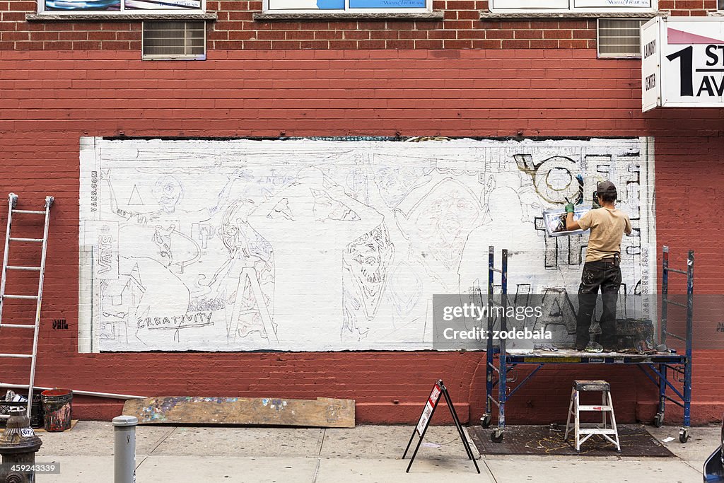 Man making a Graffiti on the Wall