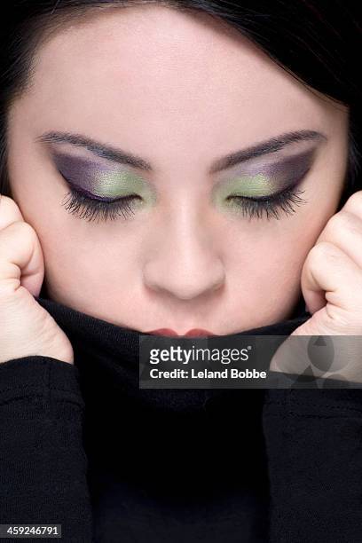 tight shot of asian woman with eyes closed - green eyeshadow stock pictures, royalty-free photos & images