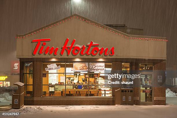 tim horton's in snowstorm - tim hortons stock pictures, royalty-free photos & images