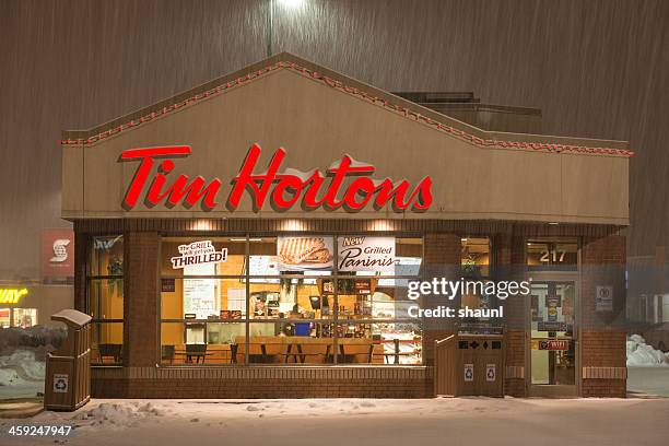 tim horton's in snowstorm - drive through stock pictures, royalty-free photos & images