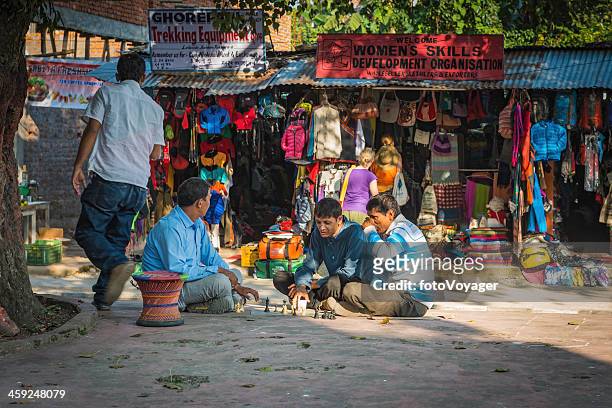 men playing chess under tree in pokhara nepal - pokhara stock pictures, royalty-free photos & images