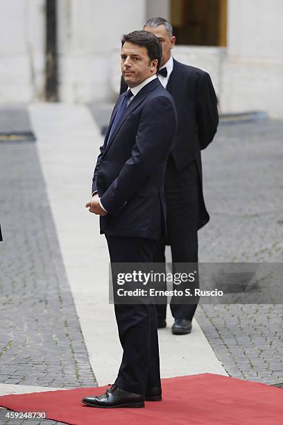 Italian Prime Minister Matteo Renzi stands upon Spanish Royals arrival at Palazzo Chigi during the Spanish Royal visit to Rome on November 19, 2014...