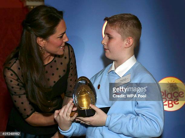 Catherine, Duchess of Cambridge presents Bailey Dunne with the Child Champion award at the Place2Be Wellbeing in Schools Awards Reception at...
