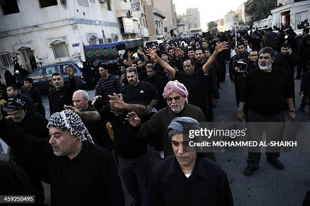 Bahraini Shiite Muslims gather in the village of Sanabis, west of Manama, on December 24 as they take part in the Arbaeen religious festival which...