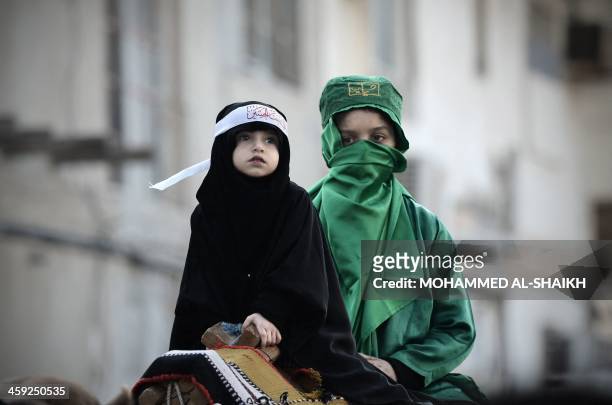 Bahraini Shiite Muslim girls take part in the Arbaeen religious festival which marks the 40th day after Ashura commemorating the seventh century...