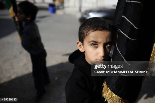 Bahraini Shiite Muslim boy takes part in the Arbaeen religious festival which marks the 40th day after Ashura commemorating the seventh century...
