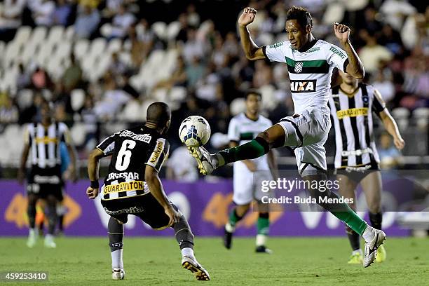 Junior Cesar of Botafogo struggles for the ball with a Marcao of Figueirense during a match between Botafogo and Figueirense as part of Brasileirao...