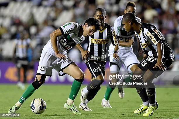 Andre Bahia and Junior Cesar of Botafogo struggle for the ball with a Pablo of Figueirense during a match between Botafogo and Figueirense as part of...