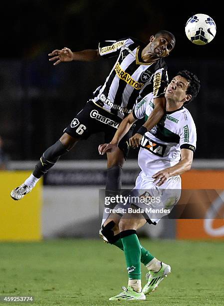 Junior Cesar of Botafogo struggles for the ball with a Felipe of Figueirense during a match between Botafogo and Figueirense as part of Brasileirao...