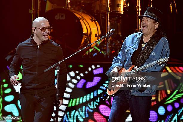 Rapper Pitbull and musician Carlos Santana perform onstage during rehearsals for the 15th annual Latin GRAMMY Awards at the MGM Grand Garden Arena on...