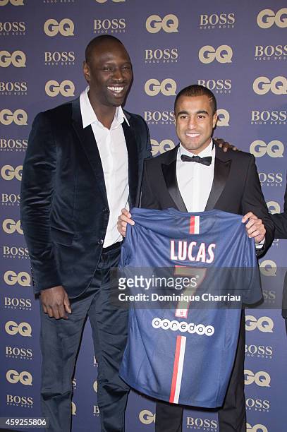 Omar Sy and Lucas Moura attend the GQ Men Of The Year Awards 2014 Photocall In Paris at Musee d'Orsay on November 19, 2014 in Paris, France.