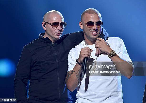 Rapper Pitbull and singer Wisin perform onstage during rehearsals for the 15th annual Latin GRAMMY Awards at the MGM Grand Garden Arena on November...