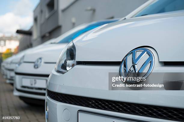 vw logo on the grille of a volkswagen up - volkswagen stock pictures, royalty-free photos & images