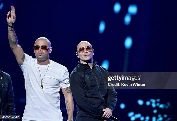 Singer Wisin and rapper Pitbull perform onstage during rehearsals for the 15th annual Latin GRAMMY Awards at the MGM Grand Garden Arena on November...