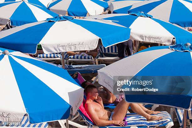 sous les parasols - gay men swimwear photos et images de collection