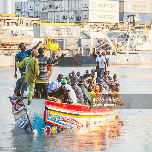 boat full of people. - banjul stock pictures, royalty-free photos & images