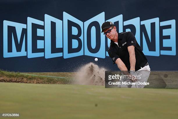 Michael Wright of Australia chips out of the bunker onto the 18th green during day one of the 2014 Australian Masters at The Metropolitan Golf Course...