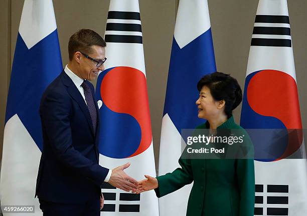 Finnish Prime Minister Alexander Stubb shakes hands with South Korean President Park Geun-Hye before starting their meeting at the Presidential Blue...