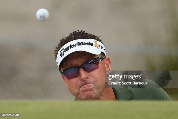 Robert Allenby of Australia plays out of a bunker on the 6th hole during day one of the 2014 Australian Masters at The Metropolitan Golf Course on...