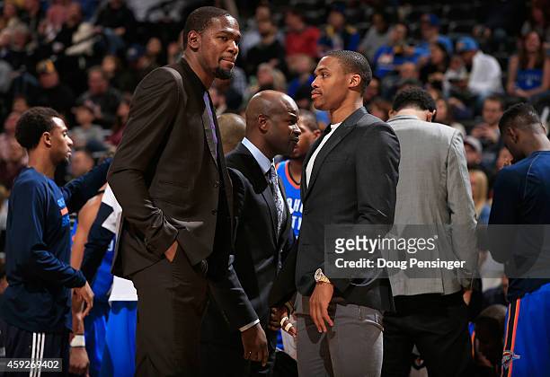 Kevin Durant and Russell Westbrook of the Oklahoma City Thunder look on from the bench as they sat out the game against the Denver Nuggets at Pepsi...