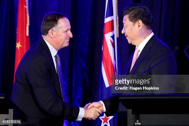 President Xi Jinping of China and Prime Minister John Key of New Zealand shake hands during a signing of NZ-China agreements at Premiere House on...