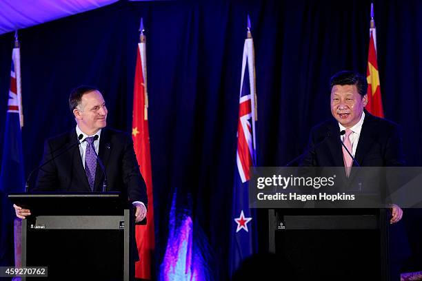 President Xi Jinping of China speaks while Prime Minister John Key of New Zealand looks on during a signing of NZ-China agreements at Premiere House...