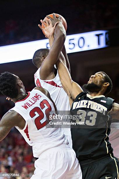 Aaron Rountree III of the Wake Forest Demon Deacons and Moses Kingsley of the Arkansas Razorbacks go after a rebound during the first half at Bud...