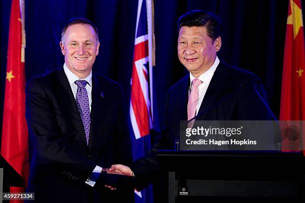 President Xi Jinping of China and Prime Minister John Key of New Zealand shake hands during a signing of NZ-China agreements at Premiere House on...
