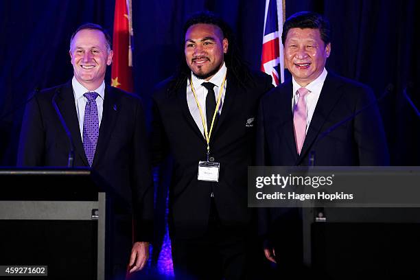 To R, Prime Minister John Key of New Zealand, All Black Ma'a Nonu and President Xi Jinping of China pose during a signing of NZ-China agreements at...