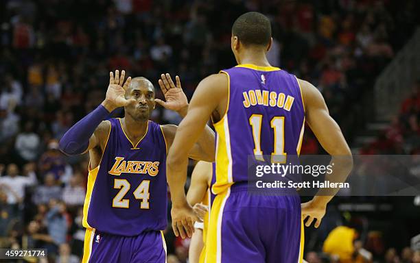 Kobe Bryant of the Los Angeles Lakers celebrates a play with Wesley Johnson their game against the Houston Rockets at the Toyota Center on November...