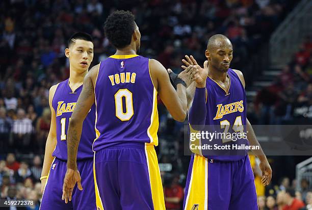 Kobe Bryant of the Los Angeles Lakers celebrates a play with Jeremy Lin and Nick Young during their game against the Houston Rockets at the Toyota...