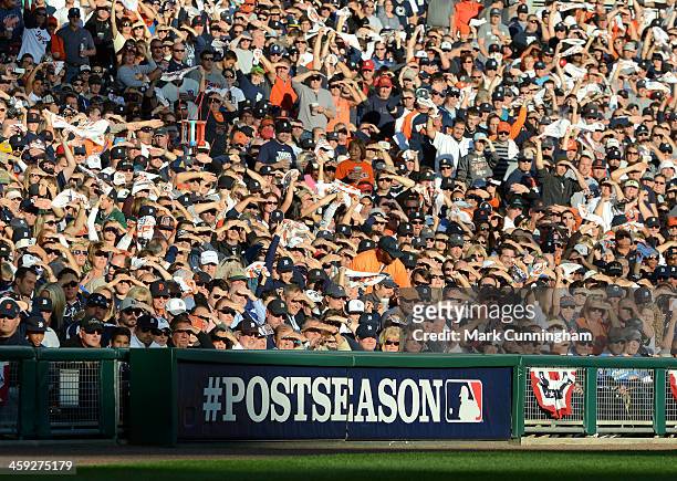 Fans cheer from the stands during Game Four of the American League Division Series between the Detroit Tigers and the Oakland Athletics at Comerica...
