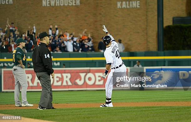 Victor Martinez of the Detroit Tigers reacts to hitting a home run as he runs the bases during Game Four of the American League Division Series...