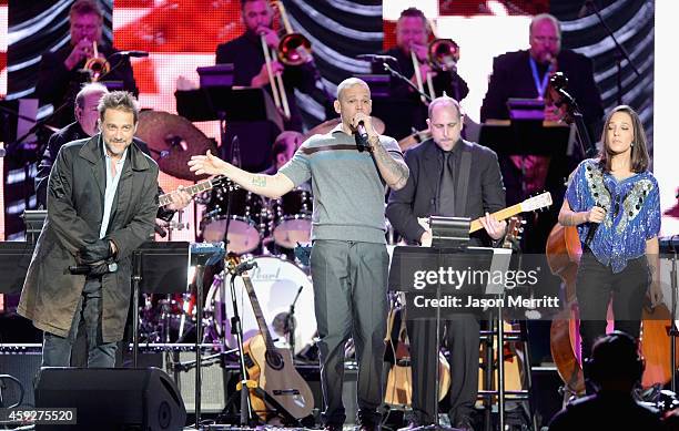 Musician Vicentico, singer Rene Perez Joglar of and Ileana Cabra Joglar of Calle 13 perform onstage during the 2014 Person of the Year honoring Joan...