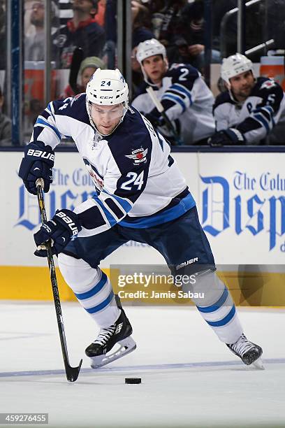 Grant Clitsome of the Winnipeg Jetsskates with the puck against the Columbus Blue Jackets on December 16, 2013 at Nationwide Arena in Columbus, Ohio.