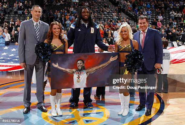 Kenneth Faried of the Denver Nuggets is recognized by the assistant general manager Arturas Karnisovas of the Denver Nuggets and Jim Tooley CEO of...