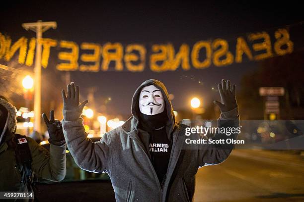 Demonstrators protest the shooting death of 18-year-old Michael Brown in the street outside the police station on November 19, 2014 in Ferguson,...