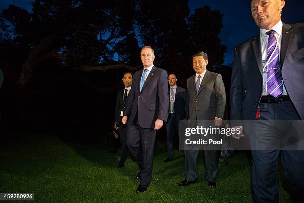 New Zealand's Prime Minister John Key and Chinese President Xi Jinping walk through the grounds of Government House, after spending the day together...