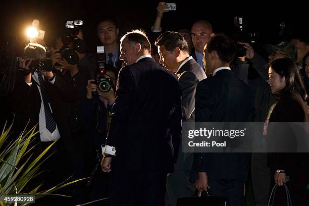 New Zealand's Prime Minister John Key and Chinese President Xi Jinping walk through the grounds of Government House, after spending the day together...