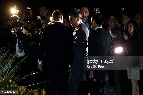 New Zealand's Prime Minister John Key and Chinese President Xi Jinping walk through the grounds of Government House, after spending the day together...