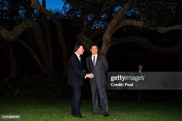 New Zealand's Prime Minister John Key and Chinese President Xi Jinping walk through the grounds of Government House, after spending the day together...