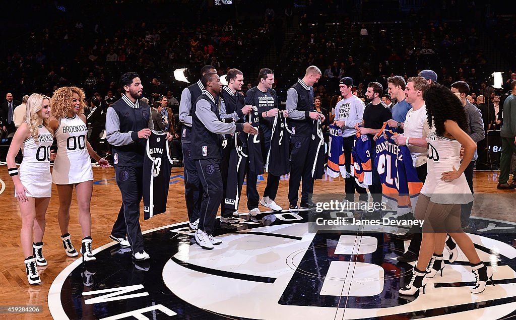 New York Islanders And Brooklyn Nets Players Exchange Jerseys