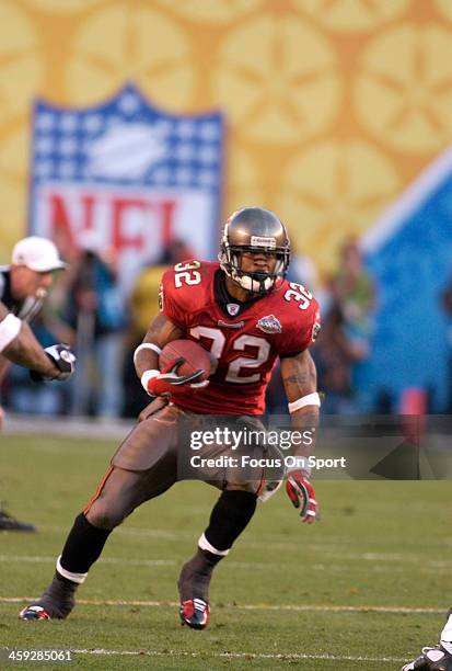 Michael Pittman of the Tampa Bay Buccaneers carries the ball against the Oakland Raiders during Super Bowl XXXVII at Qualcomm Stadium on January 26,...