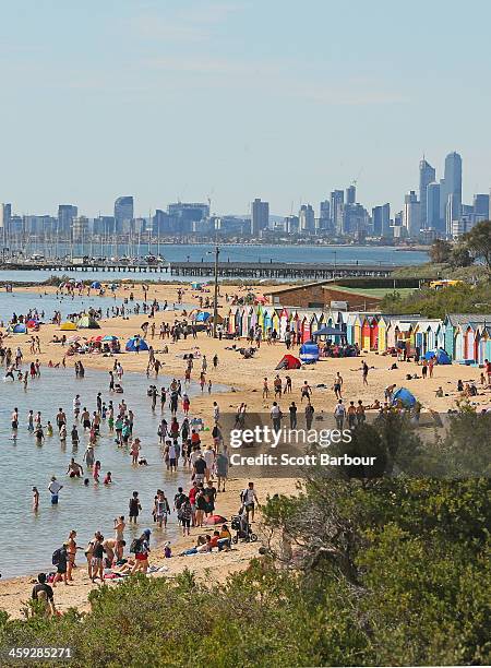 People enjoy a day at the beach on Christmas Day at Brighton Beach on December 25, 2013 in Melbourne, Australia. Brighton Beach features 82 colourful...