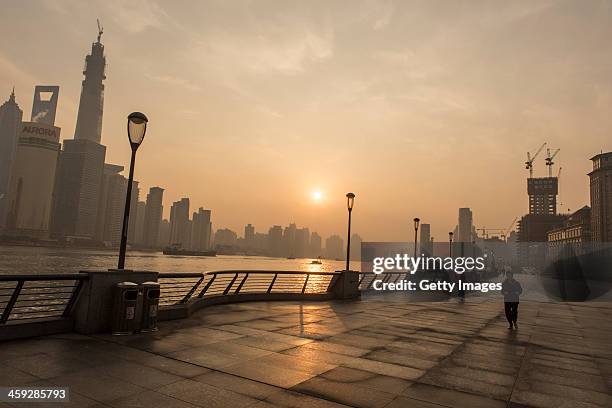 Woman runs at The Bund as heavy smog engulfs the city on December 25, 2013 in Shanghai, China. Heavy smog covered many parts of China on Christmas...